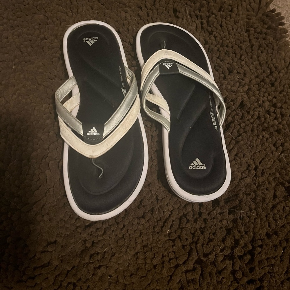 Adidas flip-flops.